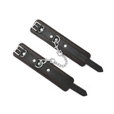 Brown leather ankle cuffs with soft velvet lining, adjustable buckle, and silver chain for BDSM play