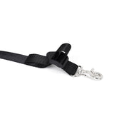 Close-up view of an adjustable black webbing belt with metal clip and clasp from the Under Mattress Restraint System in silver