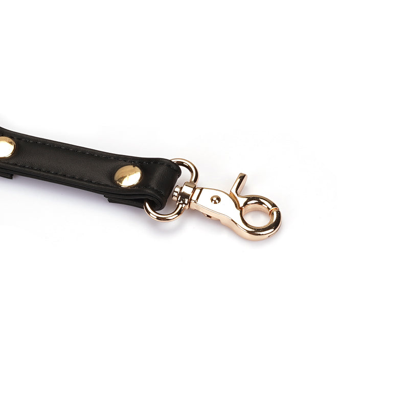 Black vegan leather strap with quick-release gold clip and rivets for bondage hogtie, part of Dark Candy collection