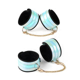 Glossy blue bondage wrist and ankle cuffs with golden chains from the Vivid Sorairo Soft Bondage Kit