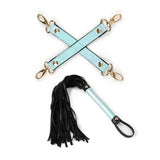 Glossy blue hogtie and black flogger from the Vivid Sorairo bondage kit, featuring golden hardware and designed for BDSM beginners