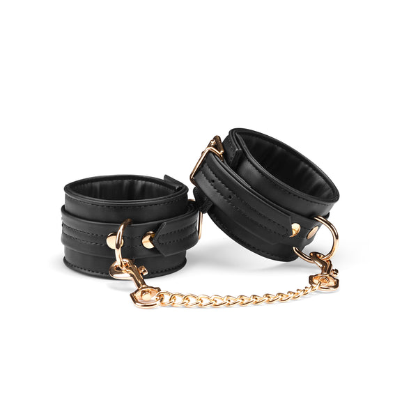 Black vegan leather ankle cuffs with gold hardware from Dark Candy collection