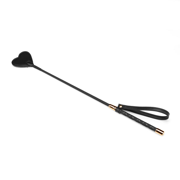 Black vegan leather BDSM riding crop with heart-shaped tip and wrist loop from the Dark Candy collection