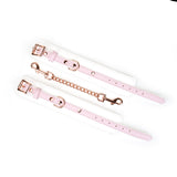 White and pink leather handcuffs from the Fairy collection with rose gold hardware, showcasing adjustable buckles and secure D-rings for BDSM play