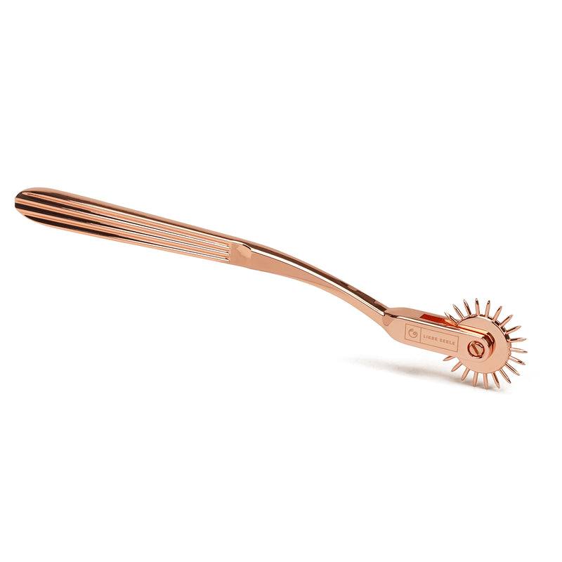 X-Rose one-row Wartenberg Pinwheel in rose gold, perfect for BDSM sensory play, 18.5cm in length, stainless steel.