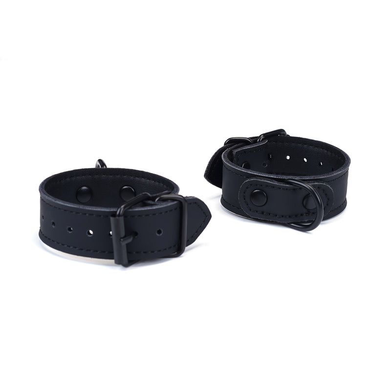 Vegan leather wrist cuffs for bondage, adjustable with metal buckles, in black