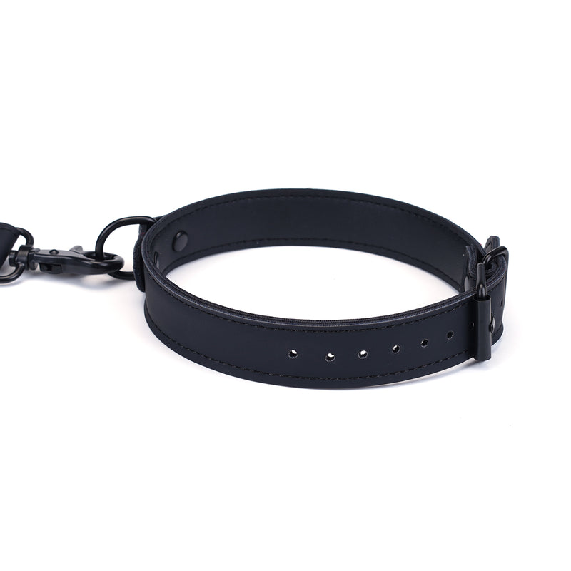 Black vegan leather collar with adjustable buckle and metal link attachments for bondage play