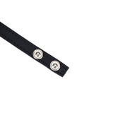 Close-up view of black faux leather cock ring with metallic snap fasteners from Vegan Fetish collection