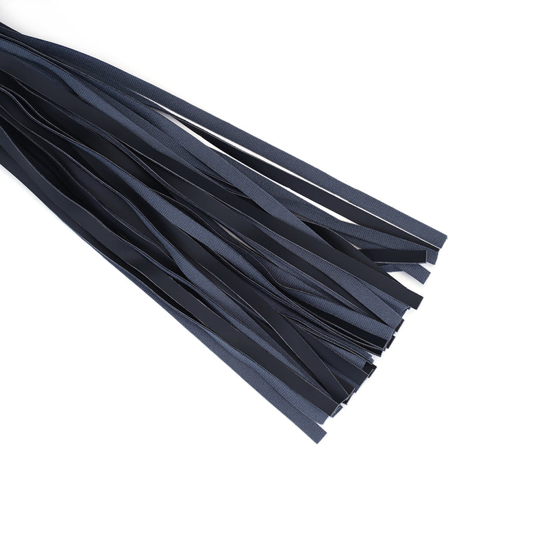 Close-up view of black vegan leather flogger fronds, featuring textured faux leather strips for ethical bondage play