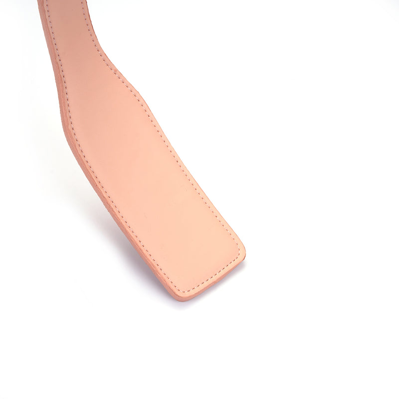 Baby pink vegan leather spanking paddle, detailed stitching, from the Dark Candy collection, designed for beginner-friendly BDSM play