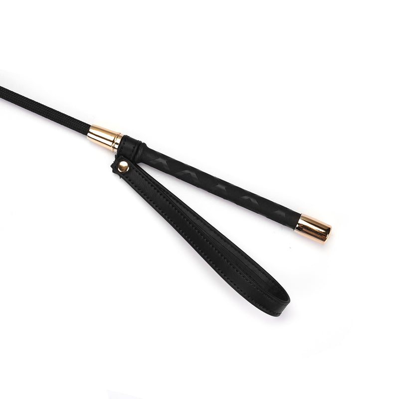 Black vegan leather BDSM riding crop with heart shape tip and golden accents from the Dark Candy collection