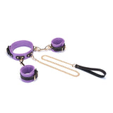 Italian leather wrist to collar set in purple with gold chain and black handle, ideal for fashion-forward bondage enthusiasts