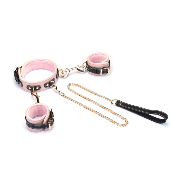 Italian Leather Wrist to Collar Set in Pink, featuring adjustable cuffs linked by a gold chain with a black leather handle, perfect for fashionable bondage enthusiasts