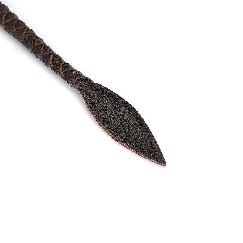 Close-up of dark brown leather bullwhip tip with braided handle, ideal for BDSM play