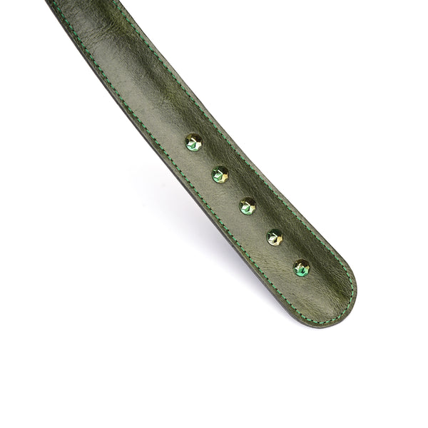 Close-up of a luxury green leather with gemstone paddle, featuring premium oil wax finish and sparkling gemstone details for enhanced sensory play.