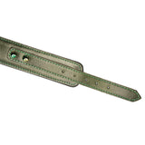 Close-up view of luxury green leather collar with gemstones and detailed stitching for BDSM play