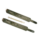 Luxury green leather wrist cuffs with gemstones and metal buckles connected by a gold-tone chain