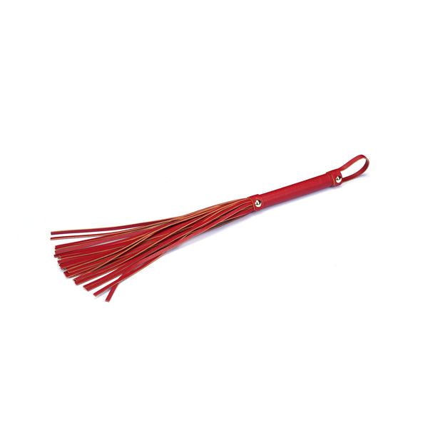 Red faux leather flogger for erotic play, featuring multiple tails and loop handle