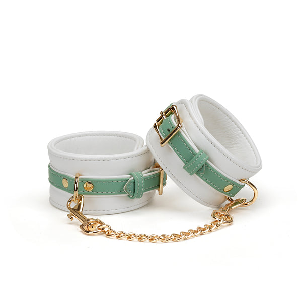 Fairy white and green leather handcuffs with gold hardware, perfect for BDSM kit enhancement and erotic submission play