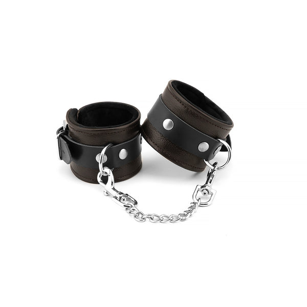 Brown leather ankle cuffs with soft lining and silver chain from the Wild Gent collection, perfect for BDSM restraint play