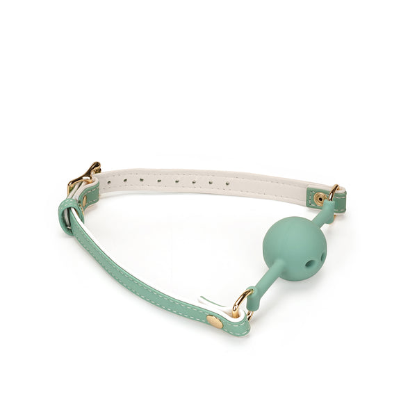 Green and white leather ball gag with breathable silicone ball and gold metal hardware from the Fairy collection
