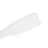 White leather spanking paddle from the Fairy collection, crafted for impact play in BDSM, featuring quality stitching and a sleek design