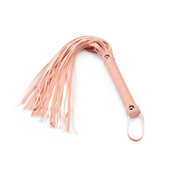 Pink vegan leather flogger whip with soft fronds and textured handle from the Dark Candy collection