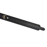 Premium black leather thigh cuffs with gold hardware details, adjustable for bondage play, part of the Dark Secret collection