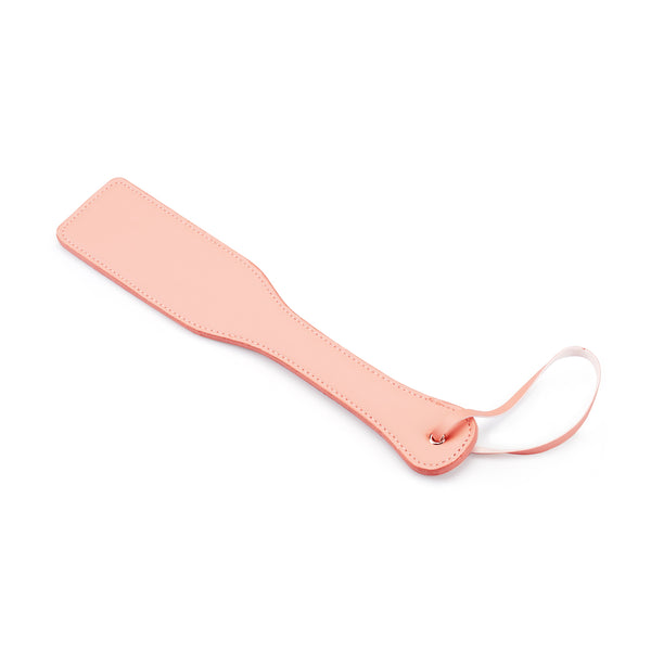 Baby pink Dark Candy vegan leather spanking paddle with wrist loop for BDSM impact play
