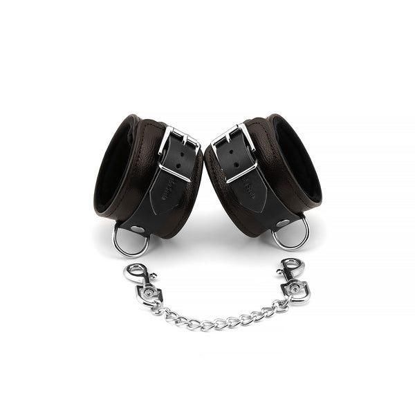 Brown leather wrist cuffs with soft velvet lining and silver hardware from the Wild Gent collection, ideal for elegant bondage play