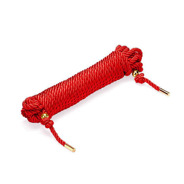 Red Shibari bondage rope in 10m length, silky cotton material with gold metal tips, ideal for Japanese rope bondage art