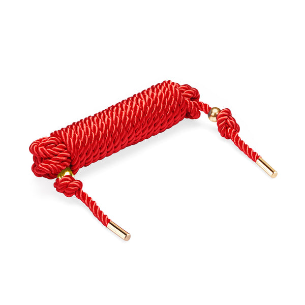 Red Shibari bondage rope with golden tips, displaying 10 meters of silky cotton used for Japanese rope bondage