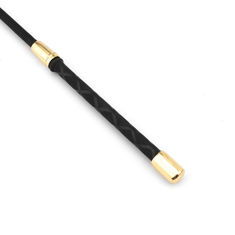 Close-up of Shining Girl Riding Crop with gold accents and braided black leather handle