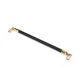 Black vegan leather spreader bar with gold-toned quick-release clips for BDSM restraint play, from the Dark Candy collection