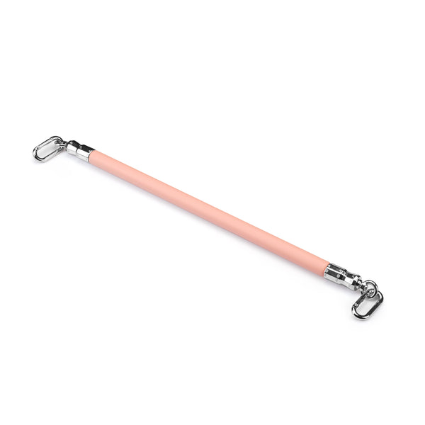 Pink vegan leather-coated leg spreader bar with silver hardware for BDSM restraint play, part of the Dark Candy collection