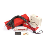 Kinbaku Ukiyoe Luxury Red Rosy Lamb Suede Leather Flogger displayed with packaging, including box, authenticity card, and Ukiyo-e art card
