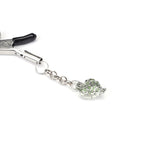 Adjustable nipple clamps with green glowing heart-shaped stone pendant for BDSM play