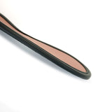 Close-up of rose gold leather blindfold with black trim for BDSM sensory play, showcasing premium construction and elegant design