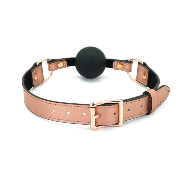 Rose gold leather strap silicone ball gag with medium-sized black ball and adjustable metal buckle, part of Rose Gold Memory collection