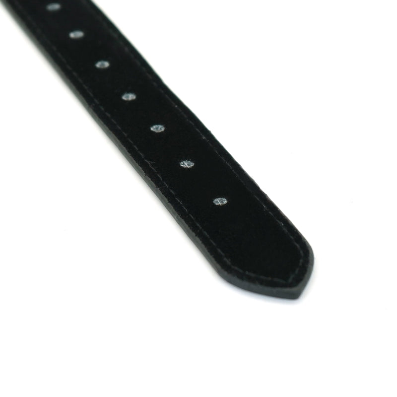 Close-up of adjustable black leather strap for rose gold silicone ball gag, part of bondage gear collection