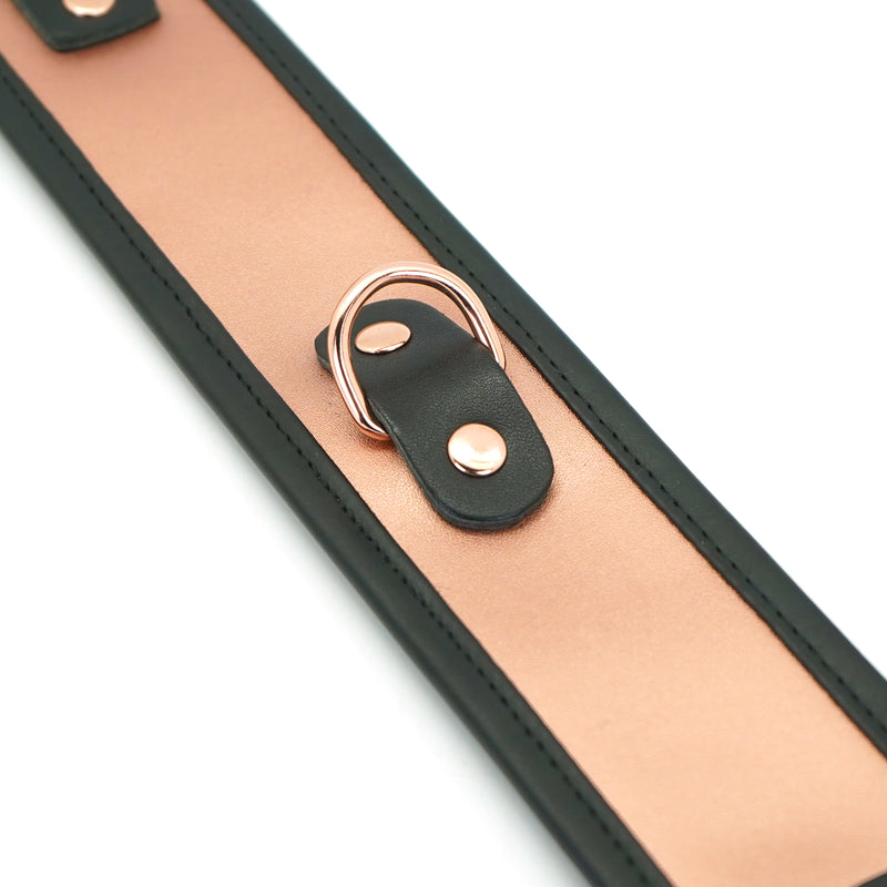 Rose gold leather collar with metal D-ring and black strap attachment for bondage play, part of the Rose Gold Memory collection