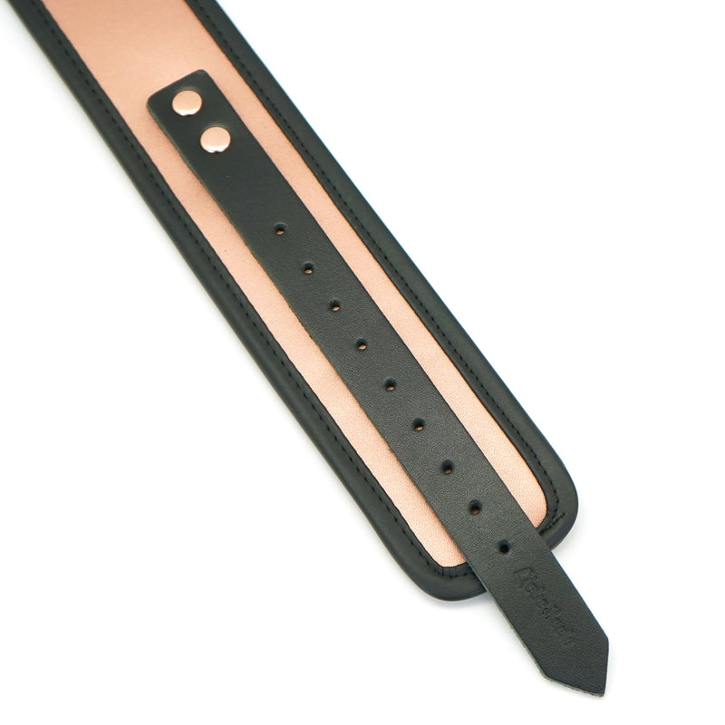 Rose gold leather bondage collar, adjustable with black trim, showcased for luxury restraint play