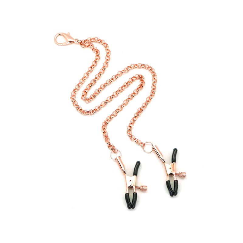 Rose gold leather bondage collar with attached nipple clamps and black rubber tips, part of the Rose Gold Memory collection