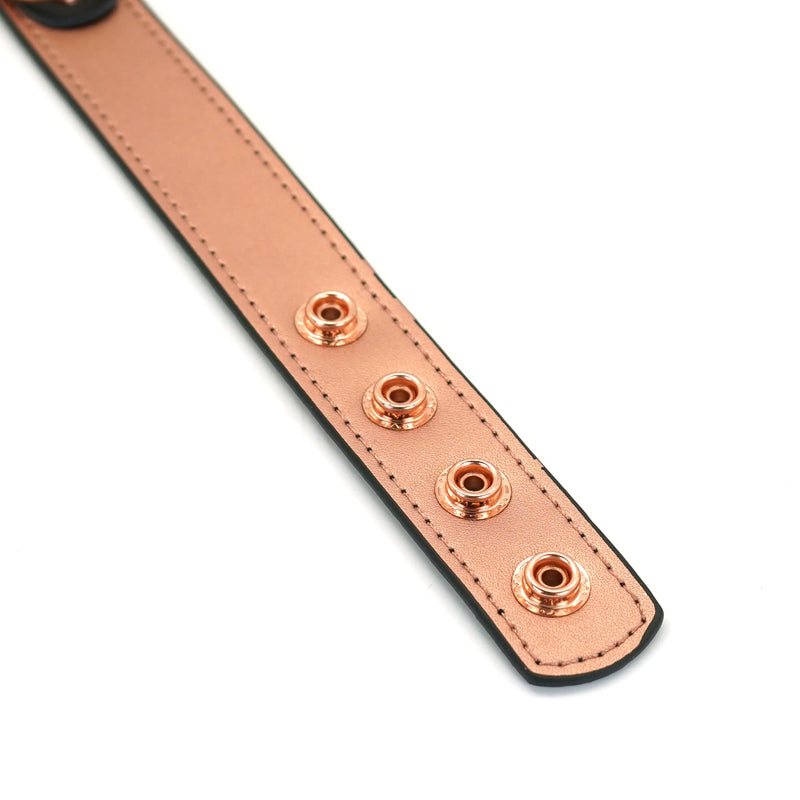 Rose gold leather bondage collar with detailed stitching and adjustable holes highlighting exquisite craftsmanship