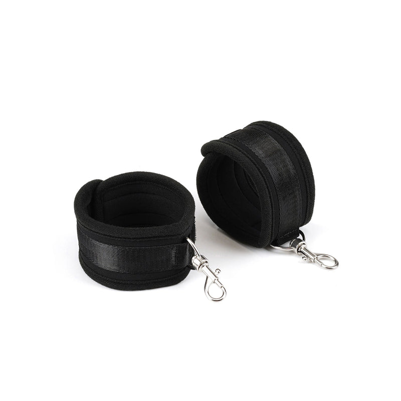 Black neoprene ankle cuffs with velcro fastening and metal clips from Bound You beginner's bondage kit