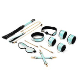 Complete Vivid Sorairo bondage kit in glossy blue with golden hardware featuring wrist cuffs, ankle cuffs, ball gag, collar with leash, blindfold, nipple clamps, flogger, and hogtie