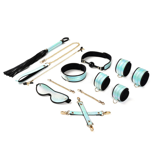 Complete Vivid Sorairo bondage kit in glossy blue with golden hardware featuring wrist cuffs, ankle cuffs, ball gag, collar with leash, blindfold, nipple clamps, flogger, and hogtie