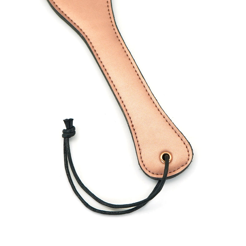 Rose gold leather spanking paddle with wrist loop from the Rose Gold Memory collection for BDSM play