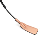 Rose gold leather spanking crop with textured corkscrew handle for BDSM impact play, part of Rose Gold Memory collection
