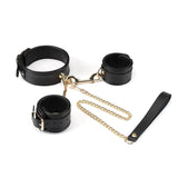 Premium black sheepskin leather bondage set with gold hardware, featuring collar with leash and handcuffs